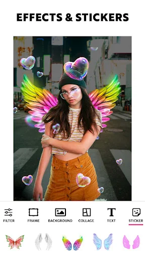 Photo effects editor displaying colorful wing stickers and heart overlays on portrait with editing toolbar