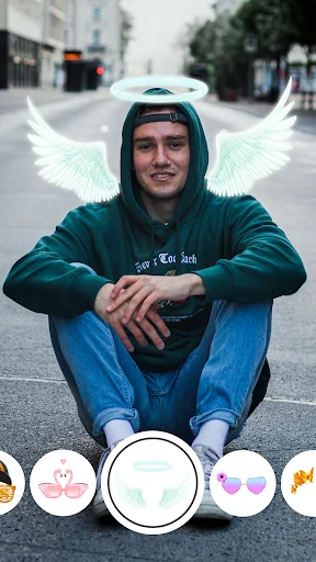 Face Live Camera angel halo and wings filter effect with filter selection interface at bottom